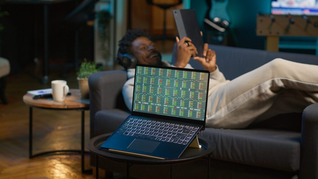 african-american-person-using-his-tablet-laying-couch-1-scaled.jpg